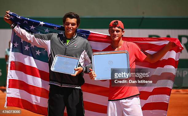 Runner up Taylor Harry Fritz of United States and winner Tommy Paul of the United States pose with their trophy after the Boy's Singles Final on day...