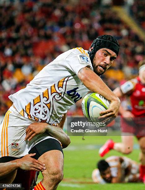 Charlie Ngatai of the Chiefs breaks from a tackle by Will Genia of the Reds during round 17 Super Rugby match between the Reds and the Chiefs at...