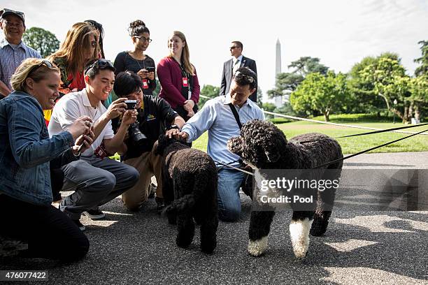 Visitors and members of the media take pictures of White House family dogs Bo and Sunny on the South Lawn of the White House, on June 6 in...