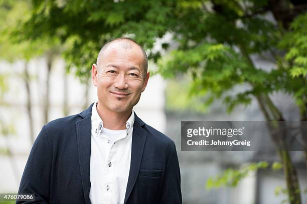 portrait of smiling japanese man - only japanese stock pictures, royalty-free photos & images