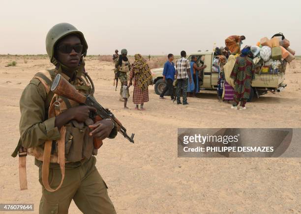 Malian army forces control a civilian vehicle on a pist on June 4 near Goundam 80 km east of Timbuktu, central Mali as they patrol during a joint...
