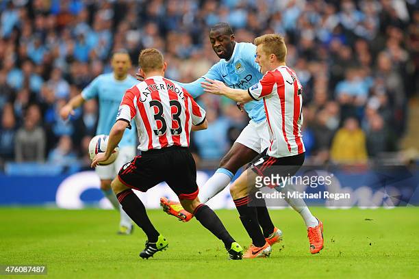 Yaya Toure of Manchester City is closed down by Lee Cattermole and Sebastian Larsson of Sunderland during the Capital One Cup Final between...