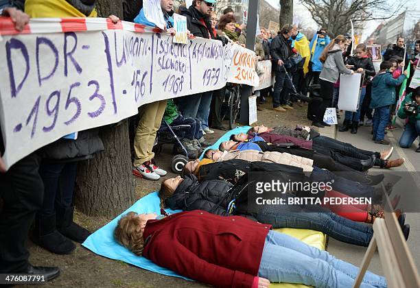 Demonstrators commemorate on March 2, 2014 in front of the Russian Embassy in Berlin with a minute of silence for victims of the power struggle in...