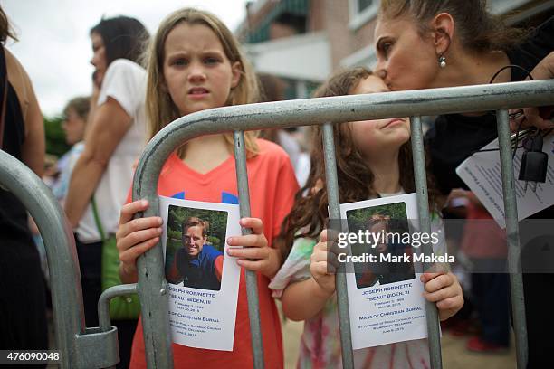 Eva Kislowski and Lauren Vernot hold a commemorative program for former Delaware Attorney General Beau Biden, as the hearse and Biden family arrive...