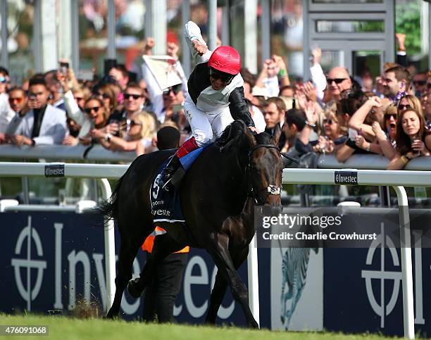 Frankie Dettori celebrates as he rides Golden Horn to win The Investec Derby at Epsom racecourse on June 06, 2015 in Epsom, England.