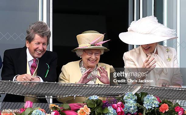 John Warren, Queen Elizabeth II and Princess Michael of Kent watch the second race of the day from the Royal Box at the Investec Derby festival at...