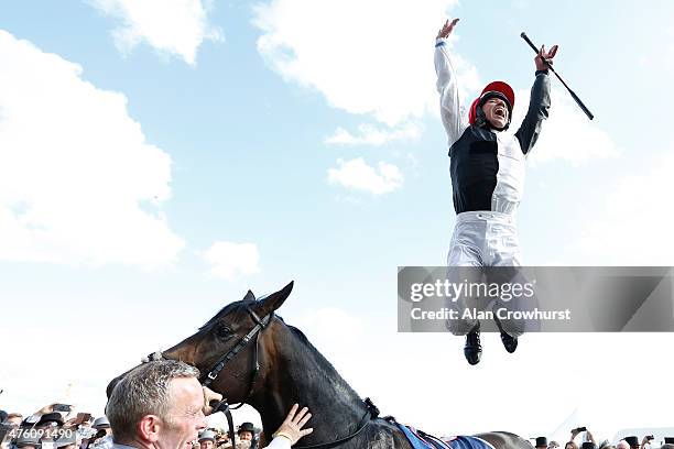 Frankie Dettori leaps from Golden Horn after winning The Investec Derby at Epsom racecourse on June 06, 2015 in Epsom, England.