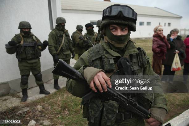 Perevalne, UKRAINE Soldiers who had taken up positions around a Ukrainian military base stand near elederly local women in Crimea on March 2, 2014 in...