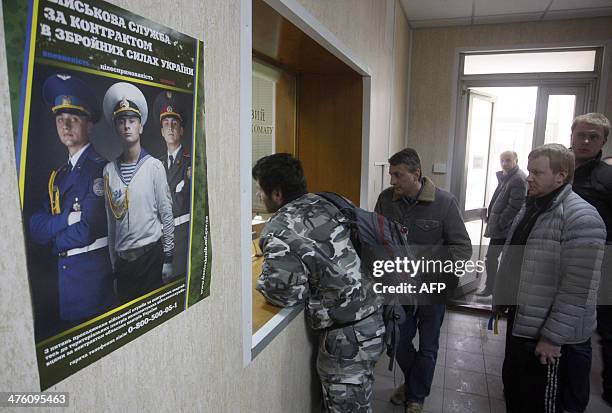 Men queue at the reception of a military enlistment office in Kiev, on March 2, 2014. Ukraine is to call up all military reservists, the head of the...