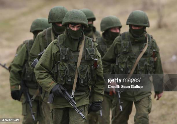 Perevalne, UKRAINE Soldiers who were among several hundred that took up positions around a Ukrainian military base walk on the base's periphery in...