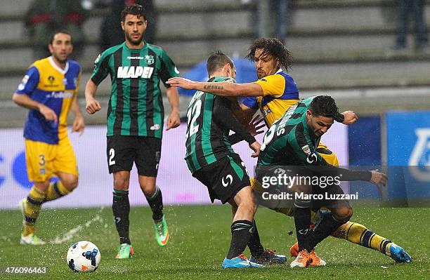 Amauri Carvalho De Oliveira of Parma FC competes for the ball with Matteo Brighi and Pedro Mendes of US Sassuolo Calcio during the Serie A match...