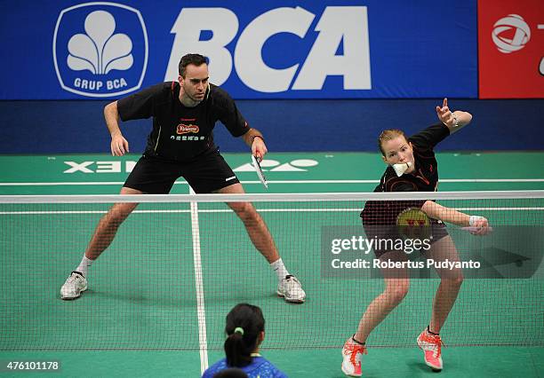 Joachim Fischer Nielsen and Christinna Pedersen of Denmark play a shot against Xu Chen and Ma Jin of China during the 2015 BCA Indonesia Open...