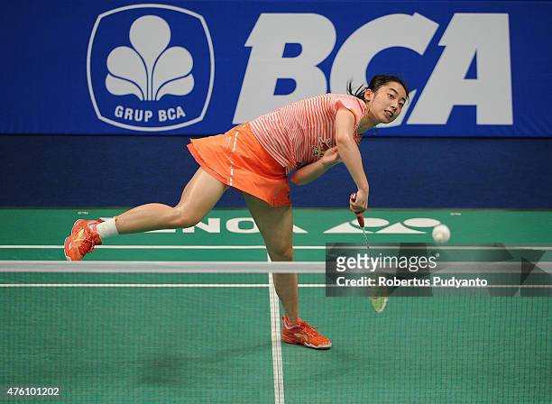 Wang Shixian of China play a shot against Ratchanok Intanon of Thailand during the 2015 BCA Indonesia Open Semifinals match at Istora Senayan on June...