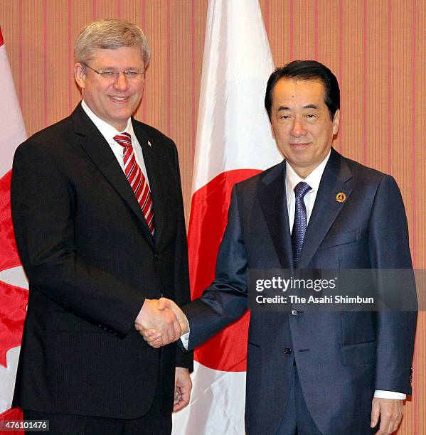 Canadian Prime Minister Stephen Harper and Japanese Prime Minister Naoto Kan shake hands during their bilateral meeting on the sidelines of the G8...