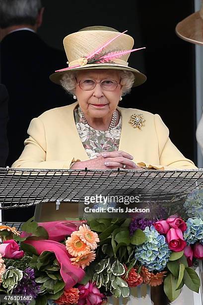 Queen Elizabeth II watches the racing from the Royal Box at the Investec Derby festival at Epsom Racecourse on June 6, 2015 in Epsom, England.