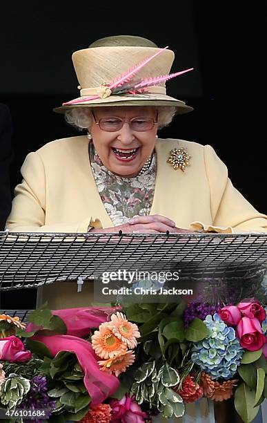 Queen Elizabeth II watches the racing from the Royal Box at the Investec Derby festival at Epsom Racecourse on June 6, 2015 in Epsom, England.