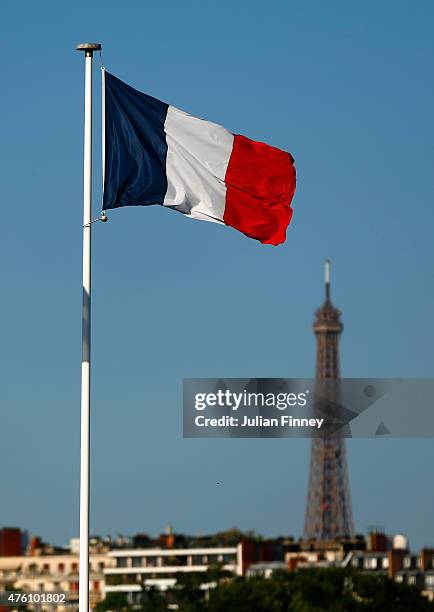 The French flag flies over Court Philippe Chatrier with The Eiffel tower seen in the background during the Women's Singles Final on day fourteen of...