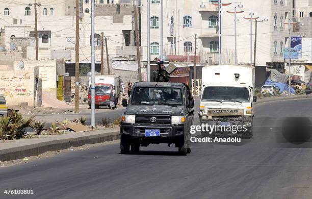 Yemeni security vehicle escorts a van carrying four of al-Qaeda militants attending a hearing at the State Security Court, as they accused of...