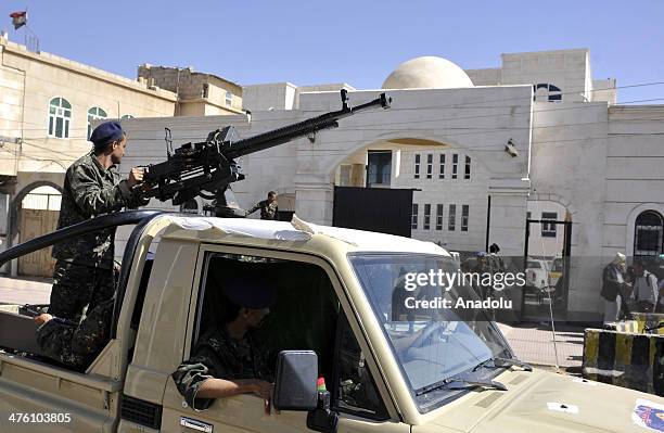 Yemeni soldiers escort a van carrying four of al-Qaeda militants to attend a hearing at the Sate Security Court as they accused of kidnapping a Swiss...