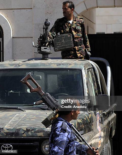 Yemeni soldiers stand guard outside the State Security Court as four of al-Qaeda militants attend a hearing as they accused of kidnapping a Swiss...