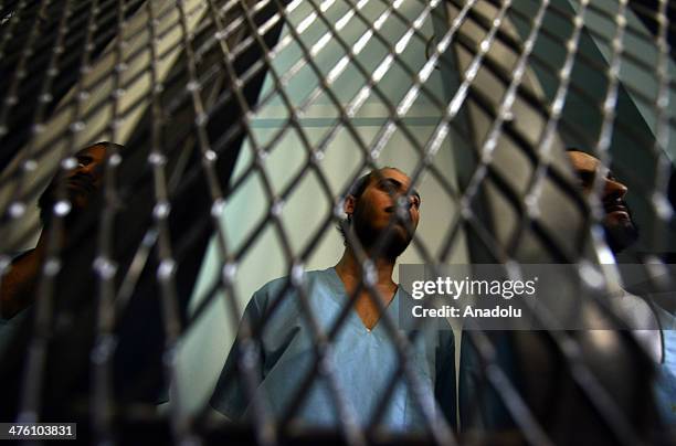 Yemeni suspected al-Qaeda militants, Husain Saleh Abd Rabbu , Yousef Saleh Abd Rabbu and Sha'aif Abdu Mohammed al-Haimi stand behind bars during a...