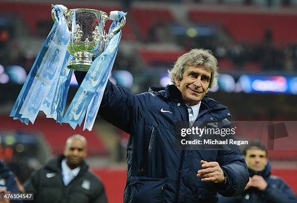 Manuel Pellegrini, manager of Manchester City celebrates victory with the trophy after the Capital One Cup Final between Manchester City and...