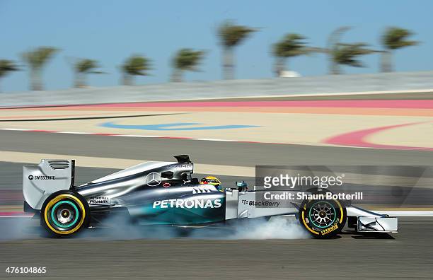 Lewis Hamilton of Great Britain and Mercedes GP locks up as he brakes while driving during day four of Formula One Winter Testing at the Bahrain...