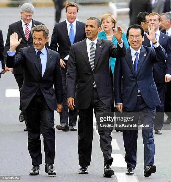 French President Nicolas Sarkozy, U.S. President Barack Obama and Japanese Prime Minister Naoto Kan walk during the G8 summit on May 26, 2011 in...