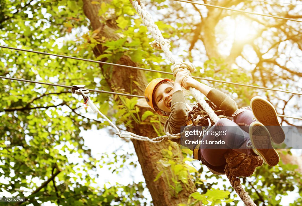 Chica divirtiéndose en el parque de aventuras al aire libre