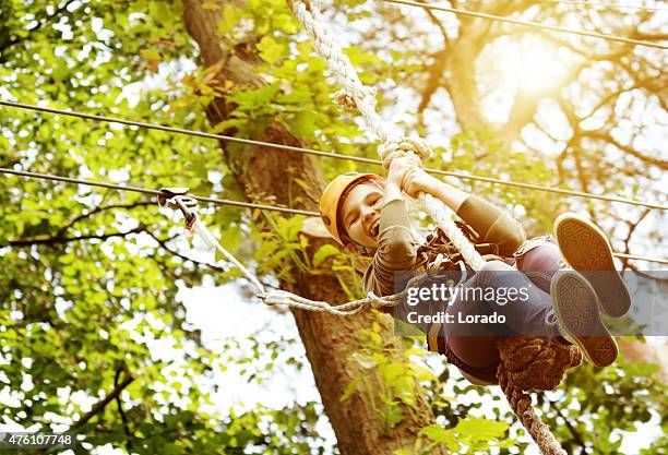 girl having fun in outdoors adventure park - climber stock pictures, royalty-free photos & images