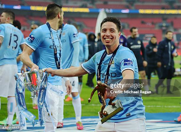 Samir Nasri of Manchester City celebrates with the trophy after the Capital One Cup Final between Manchester City and Sunderland at Wembley Stadium...