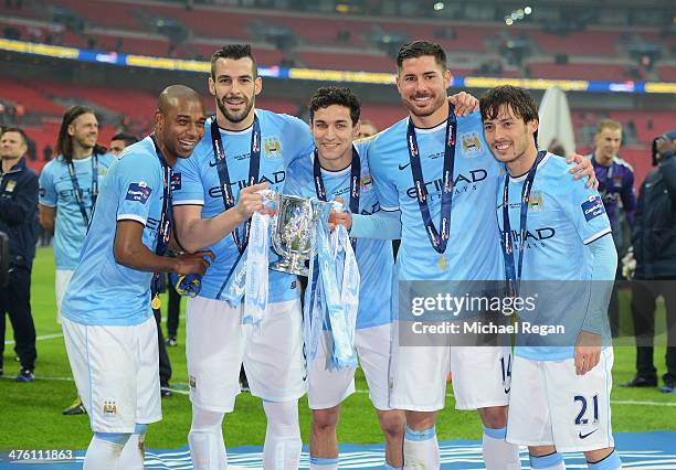 Fernandinho, Alvaro Negredo, Jesus Navas, Javi Garcia and David Silva of Manchester City pose with the trophy after the Capital One Cup Final between...