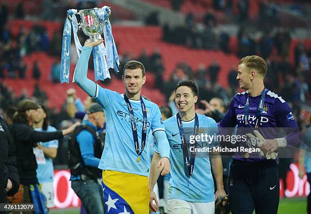 Edin Dzeko, Samir Nasri and Joe Hart of Manchester City celebrate with the trophy after the Capital One Cup Final between Manchester City and...