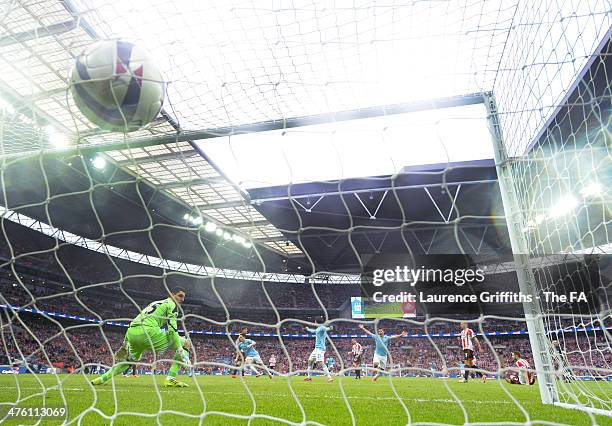 Samir Nasri of Manchester City scores past goalkeeper Vito Mannone of Sunderland during the Capital One Cup Final between Manchester City and...