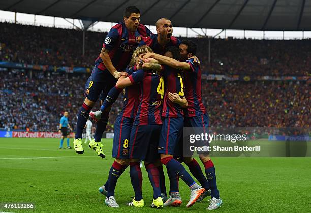 Luis Suarez and Daniel Alves of Barcelona celebrate with team mates after the goal scored by Ivan Rakitic during the UEFA Champions League Final...