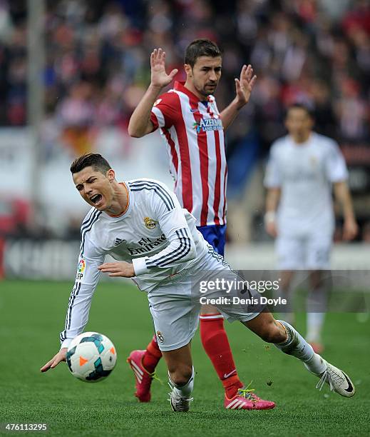 Cristiano Ronaldo of Real Madrid CF reacts after being tackled by Gabi Fernandez of Club Atletico de Madrid during the La Liga match between Club...