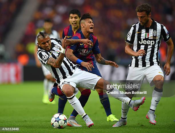 Neymar of Barcelona is challenged by Arturo Vidal and Claudio Marchisio of Juventus during the UEFA Champions League Final between Juventus and FC...