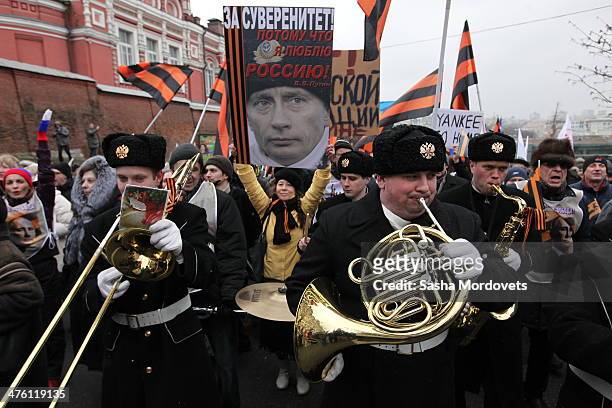 People attend a rally to support Russian President Vladimir Putin with the invasion of Crimea March 2, 2014 in Moscow, Russia. Thousands of activists...