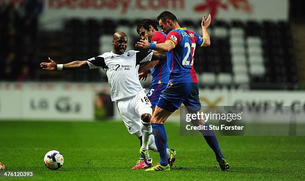 Swansea player Leroy Lita is challenged by Damien Delaney during the Barclays Premier League match between Swansea City and Crystal Palace at Liberty...