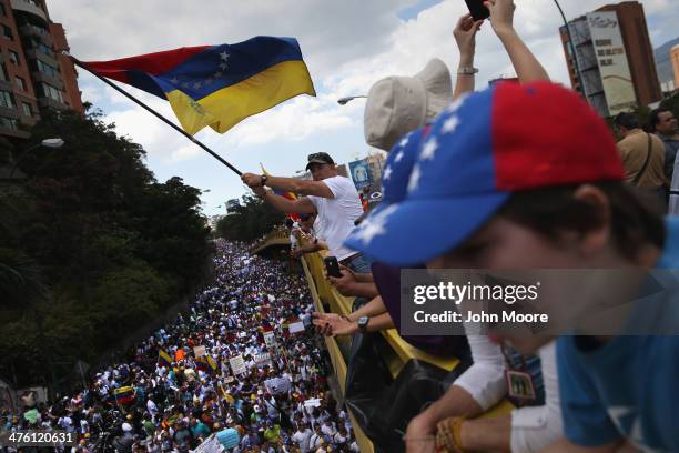 Demonstrators wave Venezuelan flags as thousands of protesters march in one of the largest anti-government demonstrations yet on March 2, 2014 in...