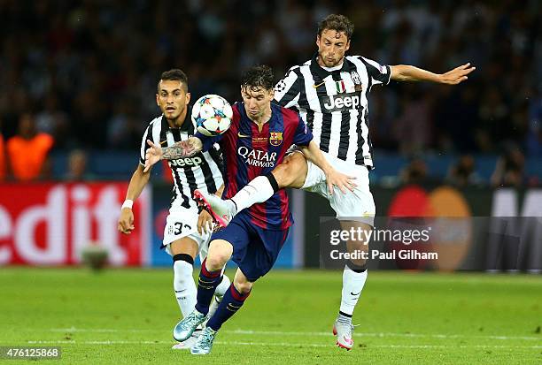 Lionel Messi of Barcelona is challenged by Claudio Marchisio of Juventus during the UEFA Champions League Final between Juventus and FC Barcelona at...