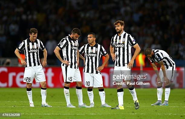 Carlos Tevez of Juventus looks dejected with team mates after the third Barcelona goal by Neymar of Barcelona during the UEFA Champions League Final...