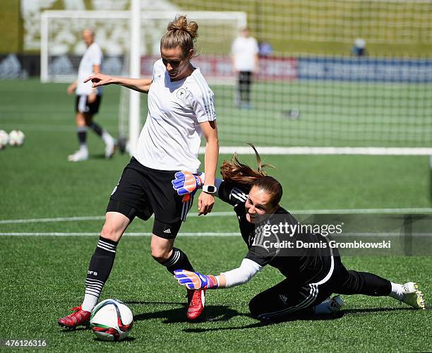 Simone Laudehr of Germany vies past goalkeeper Laura Benkarth during a training session ahead of their Group B match against Cote d'Ivoire at...