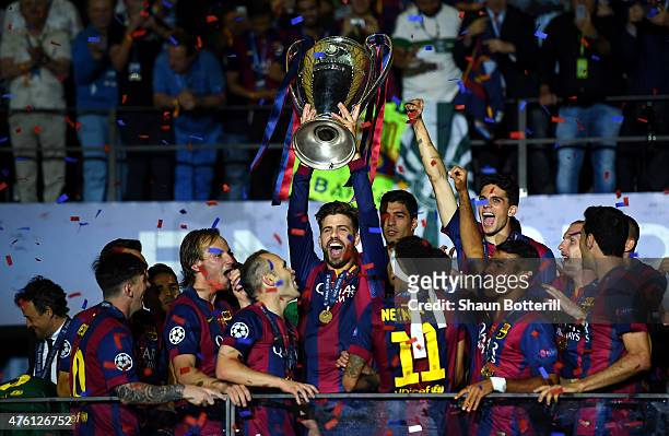Gerard Pique of Barcelona lifts the trophy as he celebrates victory with team mates after the UEFA Champions League Final between Juventus and FC...