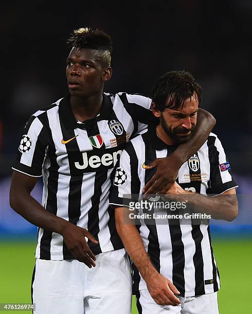 Andrea Pirlo of Juventus is consoled by Paul Pogba after the UEFA Champions League Final between Juventus and FC Barcelona at Olympiastadion on June...