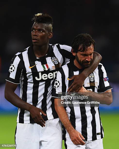 Andrea Pirlo of Juventus is consoled by Paul Pogba after the UEFA Champions League Final between Juventus and FC Barcelona at Olympiastadion on June...