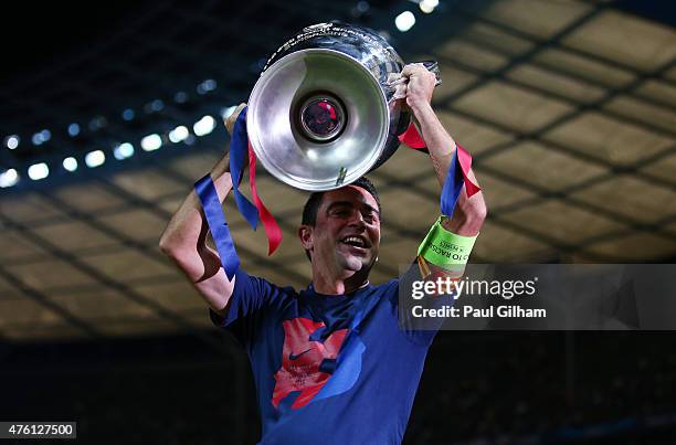 Xavi Hernandez of Barcelona lifts the trophy as he celebrates victory after the UEFA Champions League Final between Juventus and FC Barcelona at...