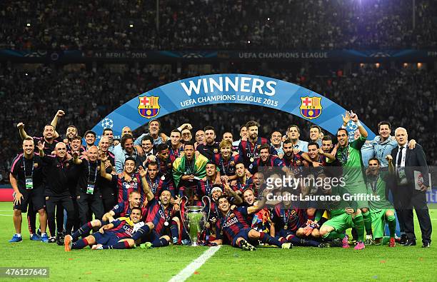The Barcelona team celebrate victory with the trophy after the UEFA Champions League Final between Juventus and FC Barcelona at Olympiastadion on...