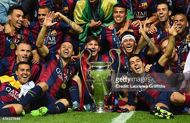 Barcelona players including Javier Mascherano, Lionel Messi, Neymar and Luis Suarez celebrate victory with the trophy after the UEFA Champions League...