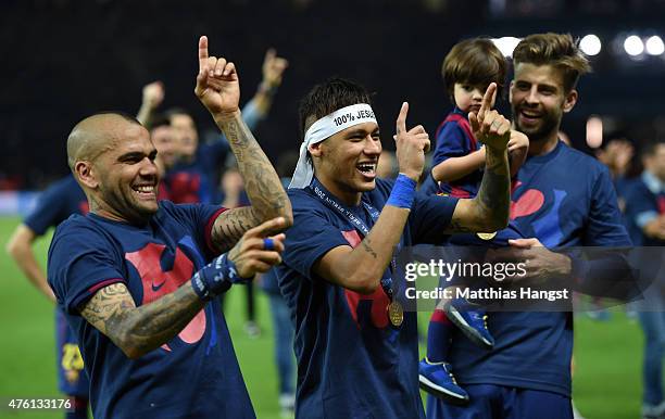 Daniel Alves and Neymar of Barcelona celebrate victory as team mate Gerard Pique looks on during the UEFA Champions League Final between Juventus and...